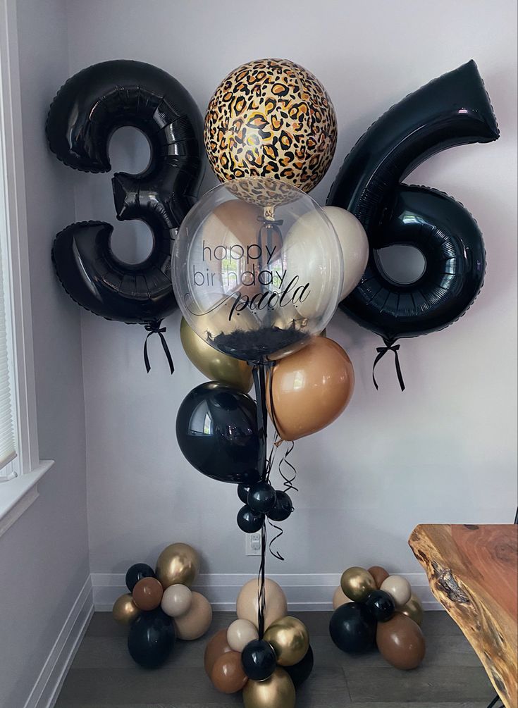 a bunch of balloons that are in the shape of numbers and leopard print on them