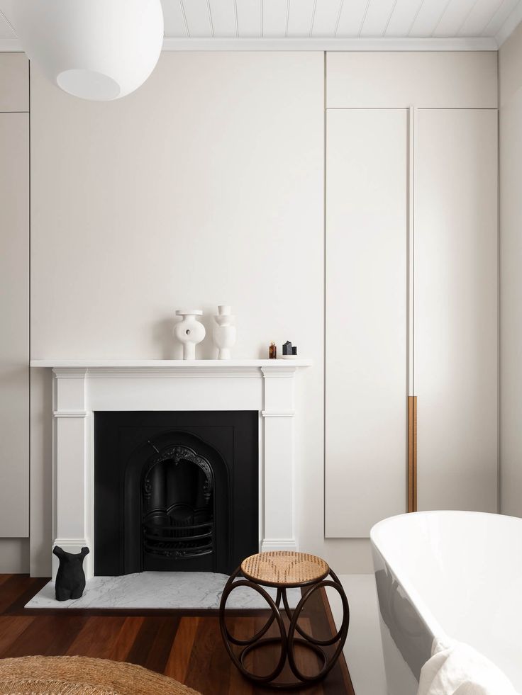 a white room with a fireplace and chair