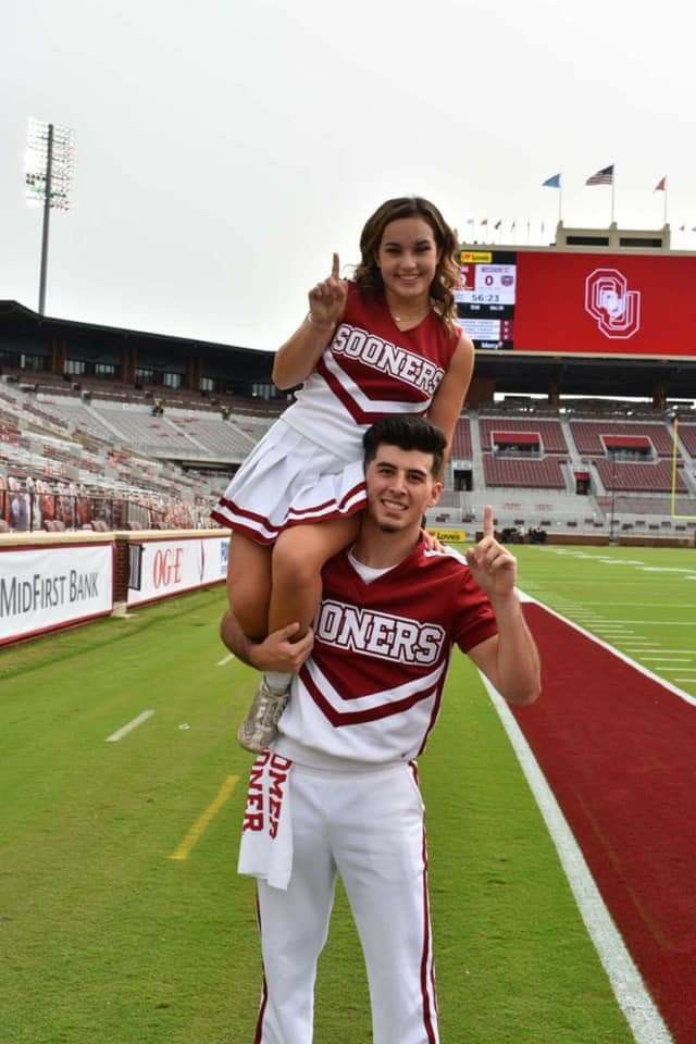 a man carrying a woman on his back at a football game