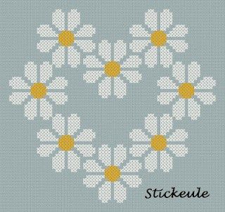 a cross stitch pattern with daisies in the shape of a heart