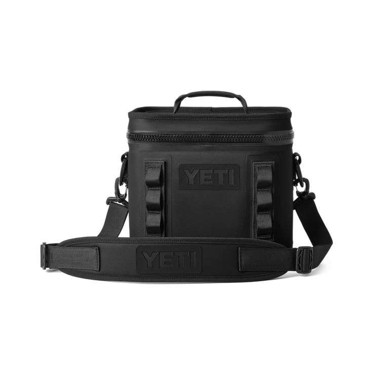 the yeti cooler bag is black and has an adjustable strap to hold it in