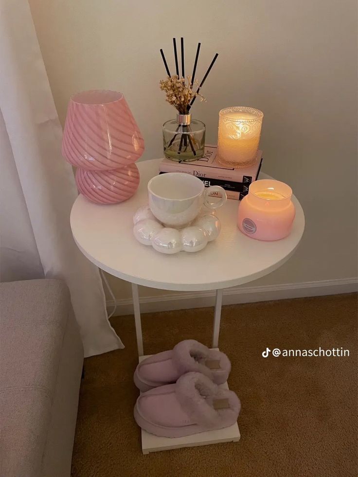 a white table topped with candles and slippers