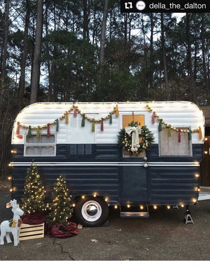 an rv decorated for christmas with garland and lights