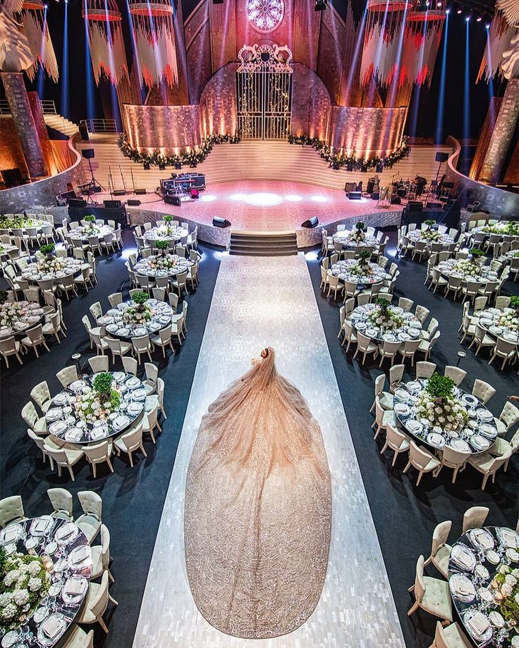 an elaborately decorated banquet hall with tables and chairs