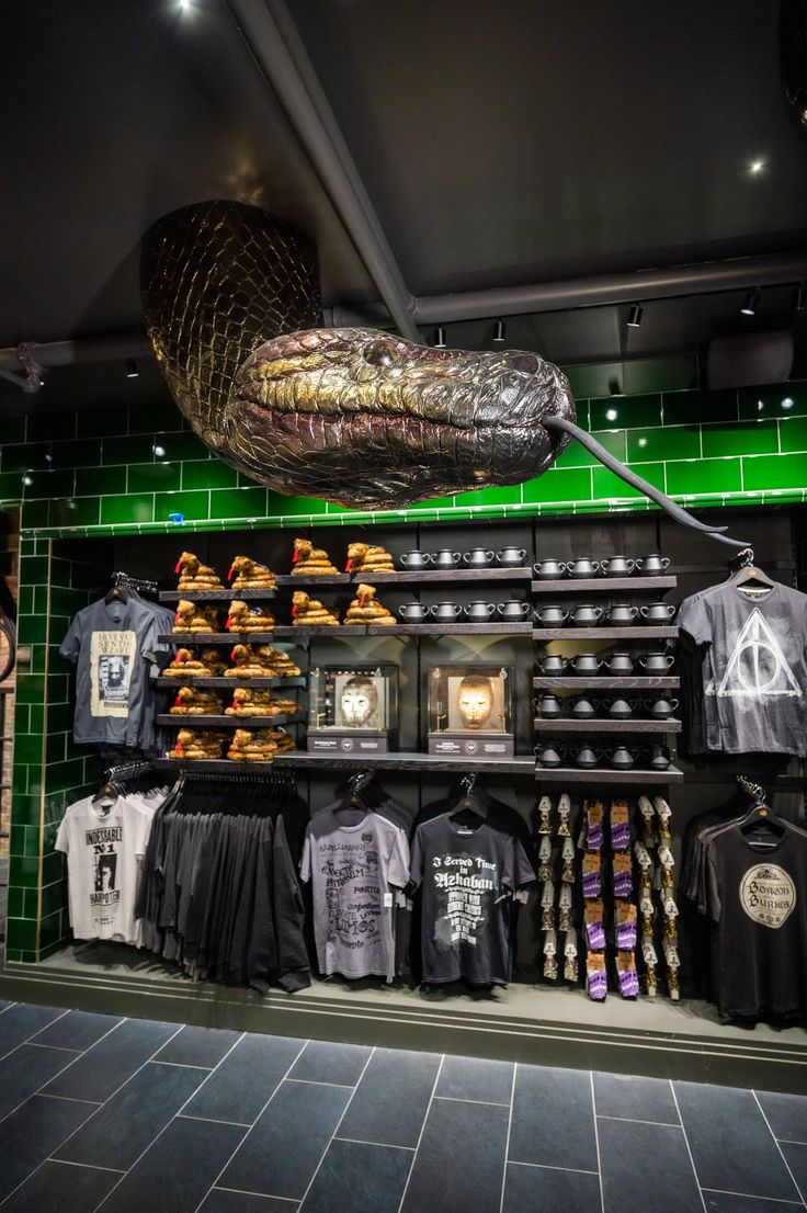 a display in a store filled with t - shirts and other items