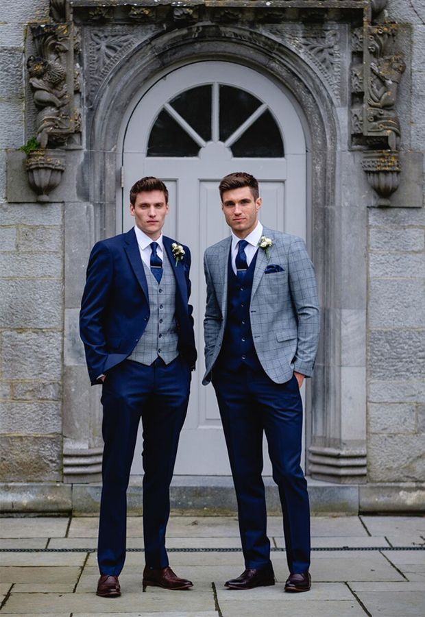 two men in suits standing next to each other