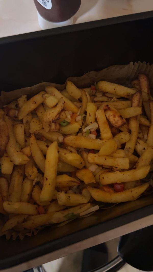 french fries are sitting in a container on the counter