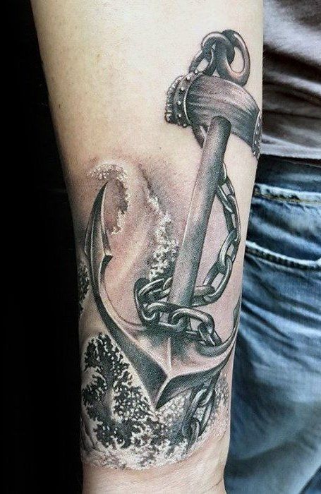 a man with a tattoo on his arm holding an anchor