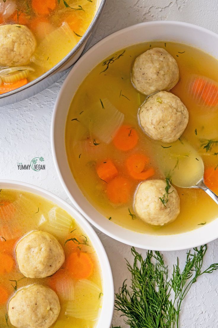 two bowls of soup with dumplings and carrots