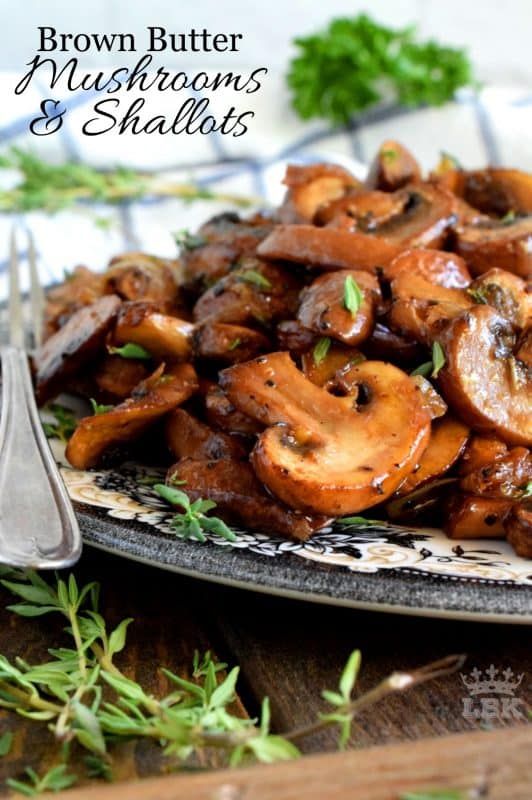 brown butter mushrooms and shallots on a plate with a fork next to the plate