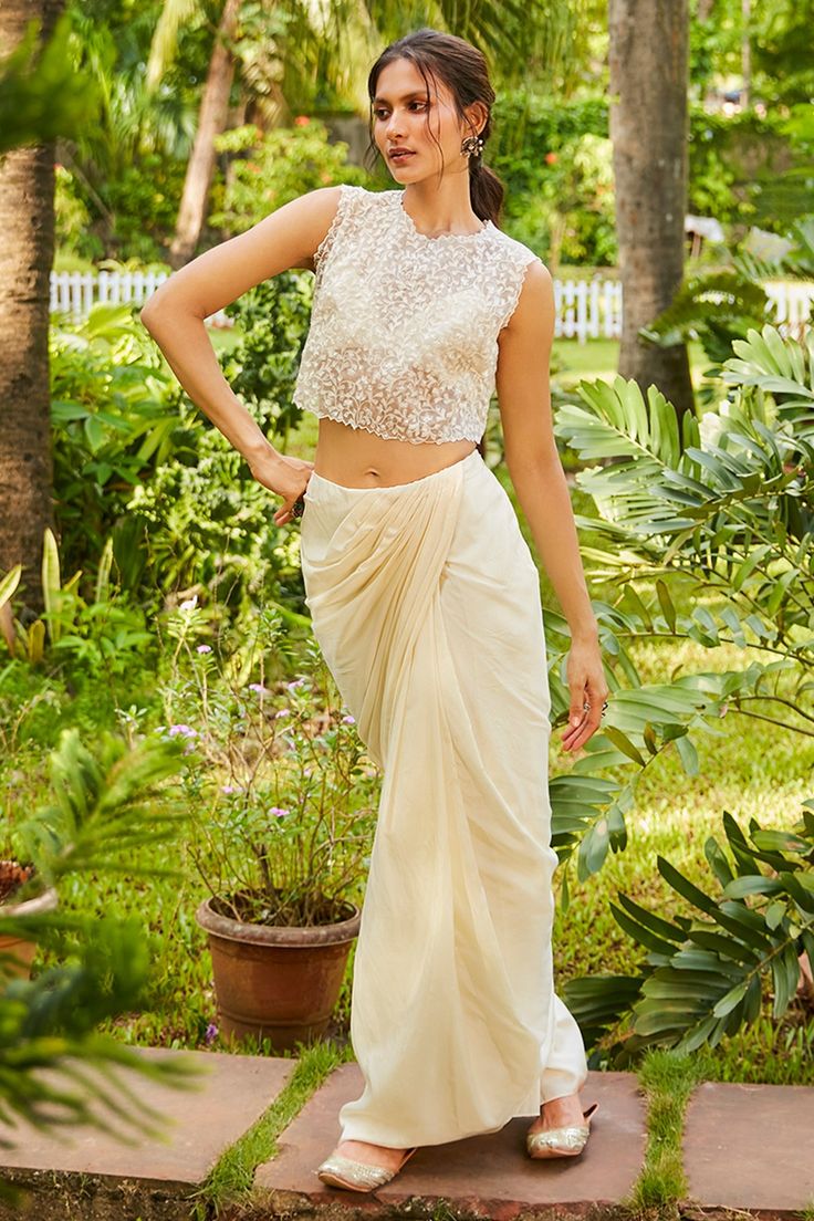 Beige saree style skirt. Paired with bustier and floral embroidered crop top.
Components:3
Pattern:Embroidery
Type of Work:Floral
Neckline:Round
Sleeve Type:Sleeveless
Fabric:Silk
Color:Beige
Other Details:
Cutwork bordered crop top
Occasion:Sangeet - Aza Fashions Beige Saree, Crop Top And Skirt Set, Saree Style, Crop Top And Skirt, Embroidered Crop Tops, Top And Skirt Set, Pattern Embroidery, Top And Skirt, Style Skirt