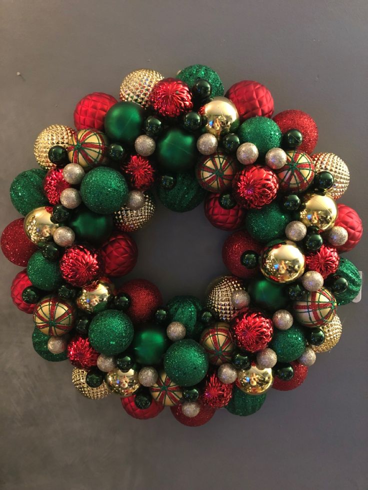 a green and red christmas ornament wreath