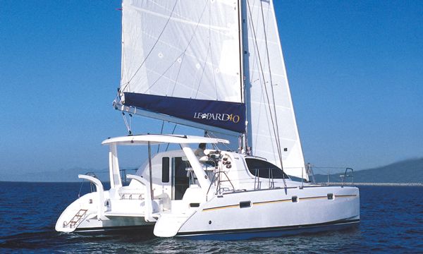 a catamaran sailing in the ocean on a sunny day