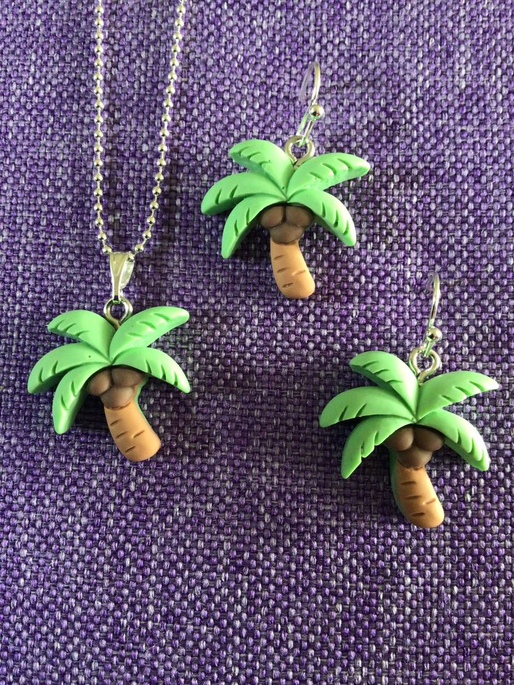 (11,518) Palm Tree Necklace or Earrings  Made from polymer clay, 7/8" x 3/4" Earrings on silver plate ear wires  Necklace on 18" sterling silver chain  These are super cute! Clay Jewelry With Matching Earrings For Gift, Novelty Polymer Clay Dangle Jewelry, Whimsical Polymer Clay Dangle Jewelry, Fun Hand Painted Dangle Jewelry, Hand Painted Fun Dangle Jewelry, Whimsical Clay Jewelry For Gifts, Whimsical Clay Jewelry Gift, Silver Polymer Clay Pendant Jewelry, Cute Resin Jewelry With Matching Earrings