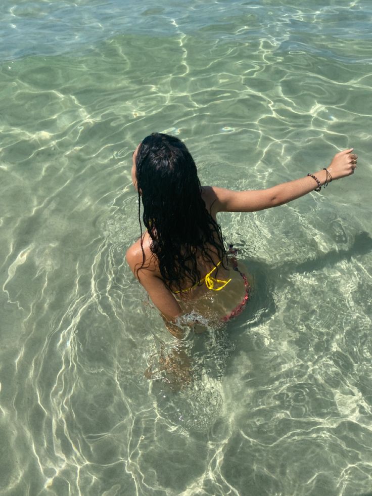 girl with brown long hair and colorful bikini playing in the crystal clear water at the beach  in Sardinia Italy on a sunny day Summer 2024 Brunette, Black Hair Girl Summer Aesthetic, Curly Hair Summer Aesthetic, Mediterranean Girl Aesthetic, Summer Brown Aesthetic, Holy Girl Summer Aesthetic, Mediterranean Hair, Summer Aesthetic Brown, Girl Travel Aesthetic