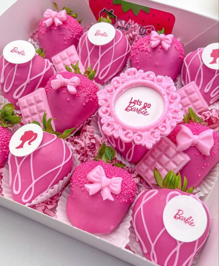 a box filled with lots of pink chocolate covered strawberries and topped with frosting