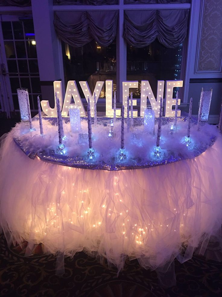 the name jaylene is spelled out in lighted letters on a table with tulle