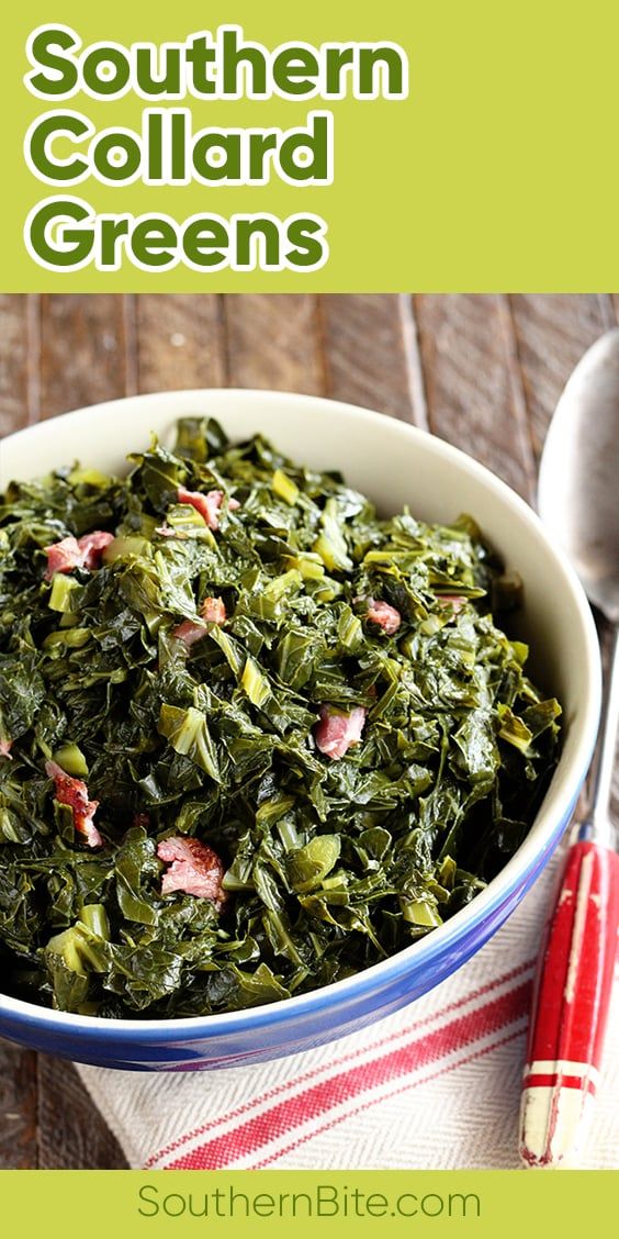 a bowl filled with greens on top of a table next to a red and white striped napkin