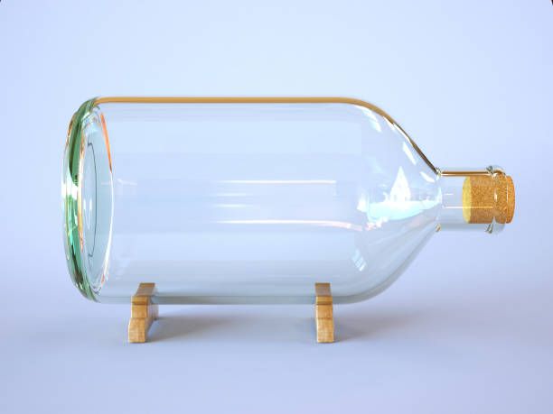 an empty glass bottle with wooden legs on a white background