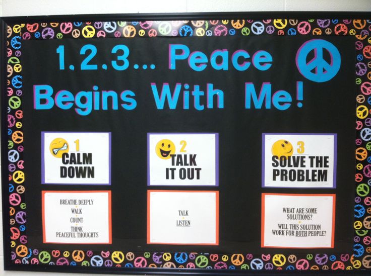 a bulletin board that has been decorated with peace signs and sayings for students to use