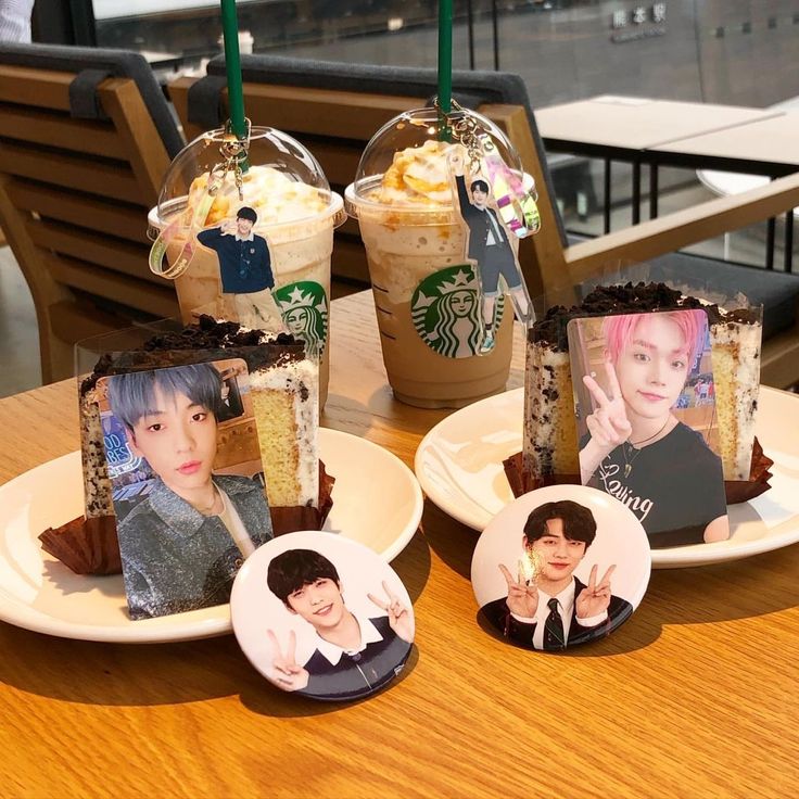 three plates with pictures of people on them and two drinks in the same mugs