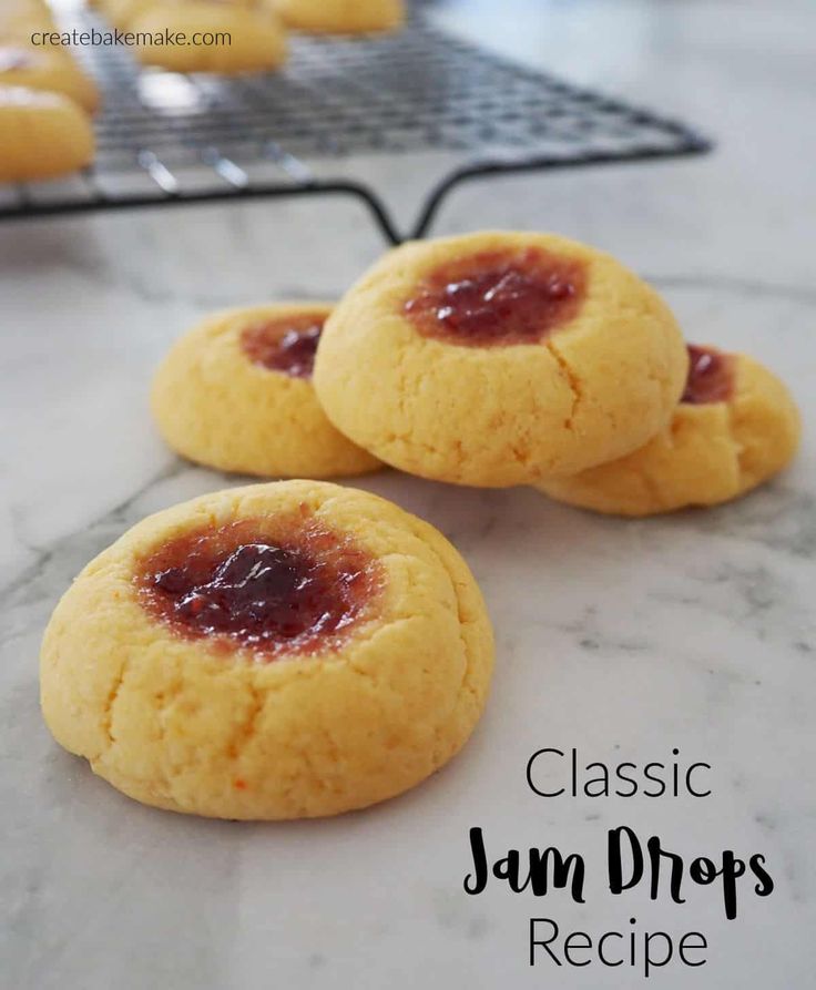 three jam drop cookies sitting on top of a counter