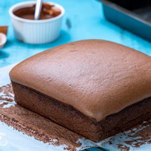 a chocolate cake sitting on top of a blue table