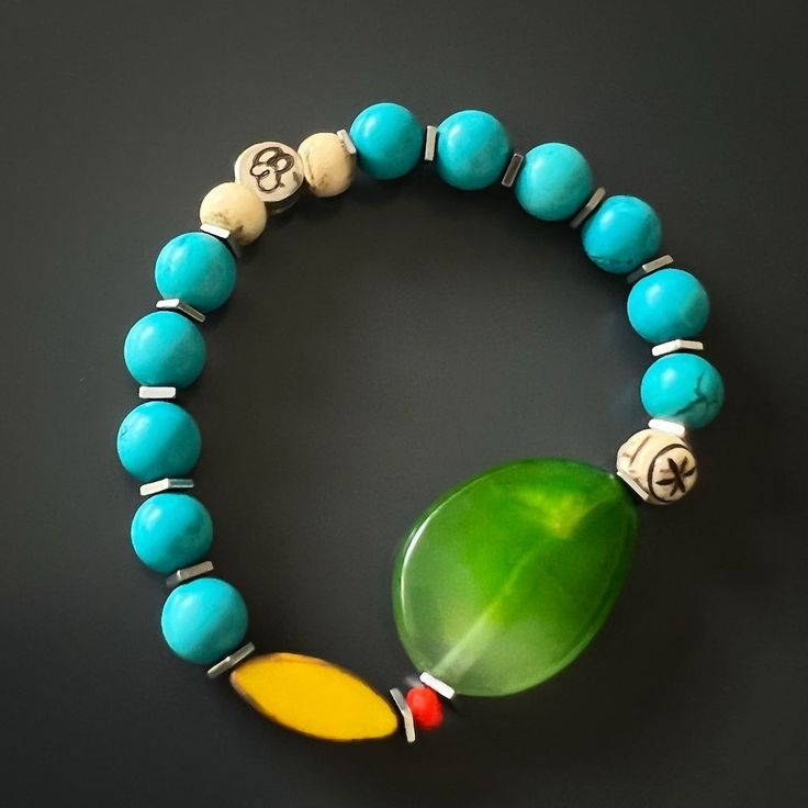 The Green Agate Summer Vibe Bracelet is a stunning accessory that exudes a sense of energy and vitality. The Green Agate stone is said to promote balance and harmony, while the other stones and beads are thought to have their own unique energy properties as well.The bracelet also features a vibrant yellow African bead, which is said to symbolize happiness and prosperity. Together, these elements create a beautiful and vibrant piece that is perfect for adding a touch of color to any summer outfit Turquoise Agate Bracelet, Handmade Turquoise Agate Bracelets, Handmade Jade Bracelets For Meditation, Bohemian Agate Stretch Bracelet For Meditation, Bohemian Blue Agate Bracelets, Handmade Bohemian Jade Stretch Bracelet, Agate Natural Stone Bracelets For Meditation, Agate Bracelets With Natural Stones For Meditation, Jade Stretch Bracelet For Meditation With Natural Stones