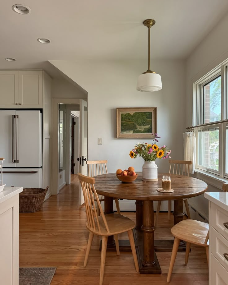 a kitchen with a table and chairs in it