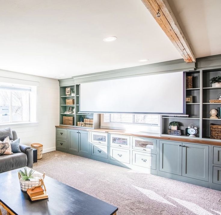 a living room filled with furniture and a flat screen tv mounted to the side of a wall