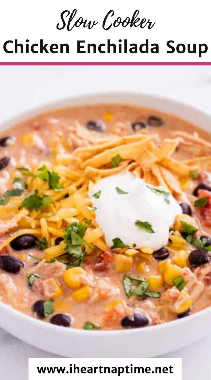 slow cooker chicken enchilada soup in a white bowl with sour cream on top