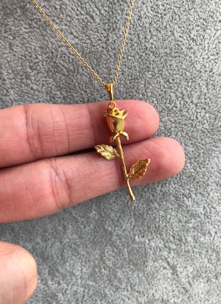 "Gorgeous Rose Necklace! You choose a 16\" or 18\" delicate yet sturdy 14k gold filled chain that holds a detailed rose pendant. (Length pictured is 18\"). On trend, it's my new favorite piece I haven't taken off! Charm measures roughly 17 mm x 40 mm and is 24k gold filled over copper. Excellent detail in this tiny piece! Arrives in a gift box! *if you need an item sooner, please message me! I am happy to ship sooner if I'm able to ❤️" Personalized Elegant Rose-colored Jewelry, Elegant Rose Necklaces For Gifts, Elegant Rose Detail Necklaces For Gifts, Elegant Rose Necklace For Gift, Elegant Gold Necklaces With Roses, Delicate Rose Gold Jewelry With Roses, Elegant Gold Necklaces With Rose Details, Rose Gold Flower Charm Necklace With Delicate Chain, Rose Gold Tarnish Resistant Charm Necklace For Anniversary