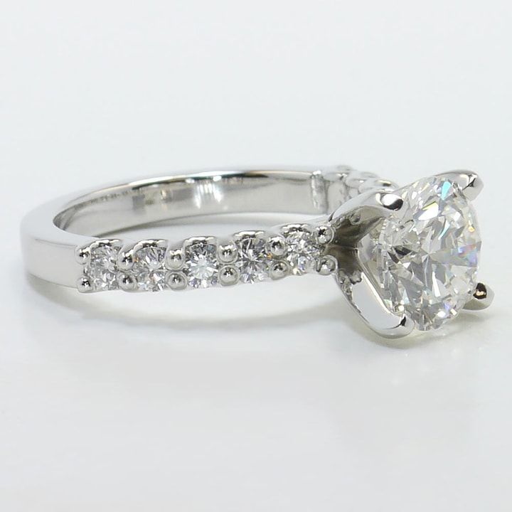 a diamond engagement ring on a white background