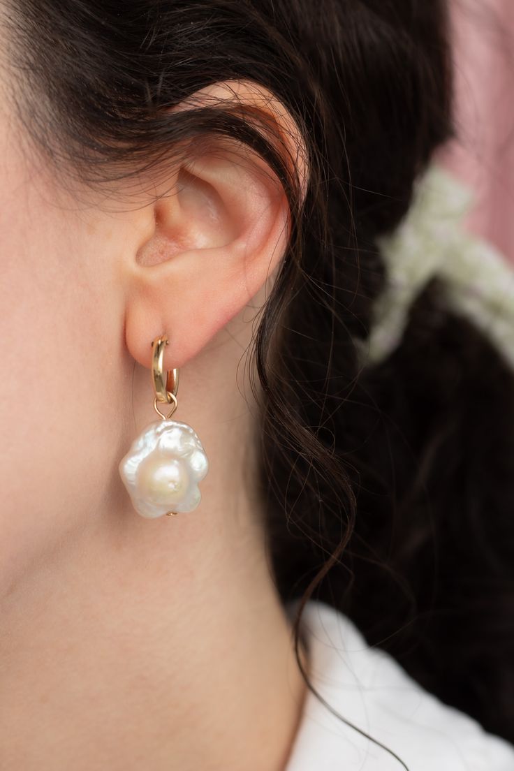 These daisy shaped freshwater pearl earrings are a unique spin on the classic Baroque pearl drops — Each set of pearls are different and won't look exactly like the ones pictured due to the nature of freshwater pearls. Choose from the drop-down menu if you want 14k gold-filled huggies hoops included, or just the charms alone. Each item is made-to-order. Please allow a processing time of 14 business days. We value your patience and appreciation of the handmade process! Delicate Pearl Earrings With Pearl Pendant, Delicate Pearl Earrings With Pendant, Delicate Pearl Drop Earrings With Flower Shape, Delicate Pearl Drop Earrings In Flower Shape, Delicate Flower Shape Pearl Drop Earrings, Flower Shaped Pearl Earrings With Pearl Drop, Delicate Baroque Pearl Earrings With Pearl Charm, Delicate Pearl Charm Flower Earrings, Delicate Drop Flower Earrings With Pearl Charm