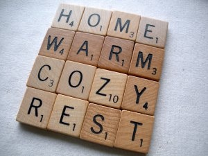 scrabble tiles spelling the words home, warm, cozy, rest