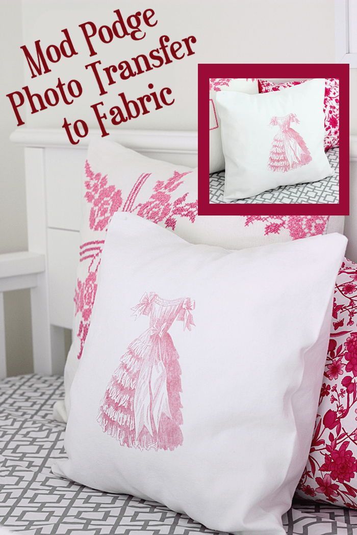 a white bed topped with pillows next to a pink and white pillow cover on top of a bed