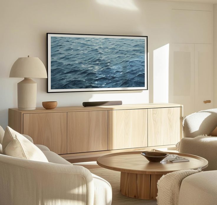 a living room filled with furniture and a flat screen tv mounted to the side of a wall