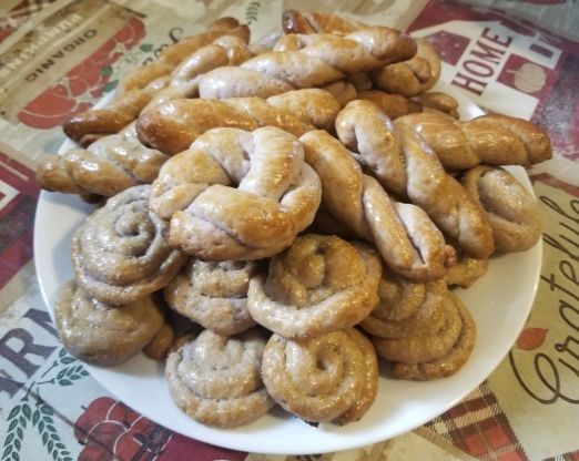 a white plate filled with donuts on top of a tablecloth covered table cloth