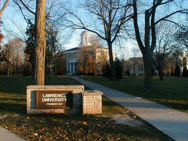 the sign for lawrence university is in front of some trees and grass on a sunny day