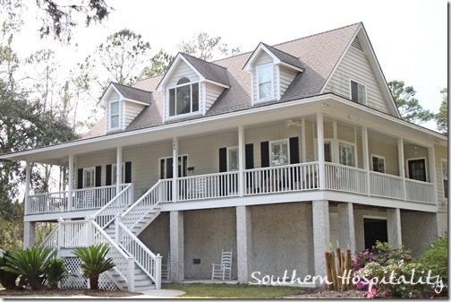 a large white house with lots of windows and balconies on the second story