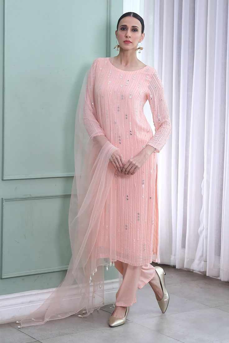 Rose pink hand embroidered kurta in mirror, sequins and cutdana work. Paired with net dupatta and pant.
Components:3
Pattern:Embroidered
Type of Work:Mirror work, Sequins, Cutdana work
Neckline:Round
Sleeve Length:Three quarter
Fabric:Georgette, Shantoon, Net
Color:Pink
Other Details:
Bead tassel dupatta
Occasion:Sangeet, Puja - Aza Fashions Pink Kurta, Fashionable Saree Blouse Designs, Kurta Set For Women, A Line Kurta, Palazzo Set, Plain Dress, Gray Silk, Net Dupatta, Kurta With Pants