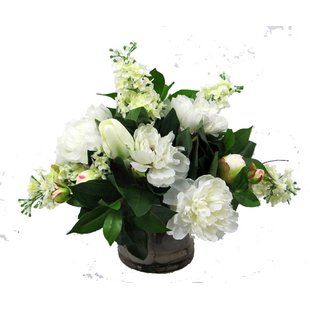 a vase filled with white flowers on top of a table