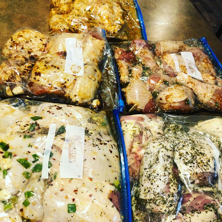 four plastic trays filled with different types of meat and seasoning on top of each other