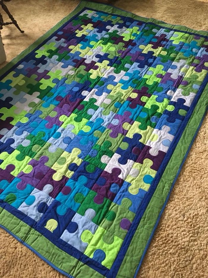 a colorful quilt is laying on the floor