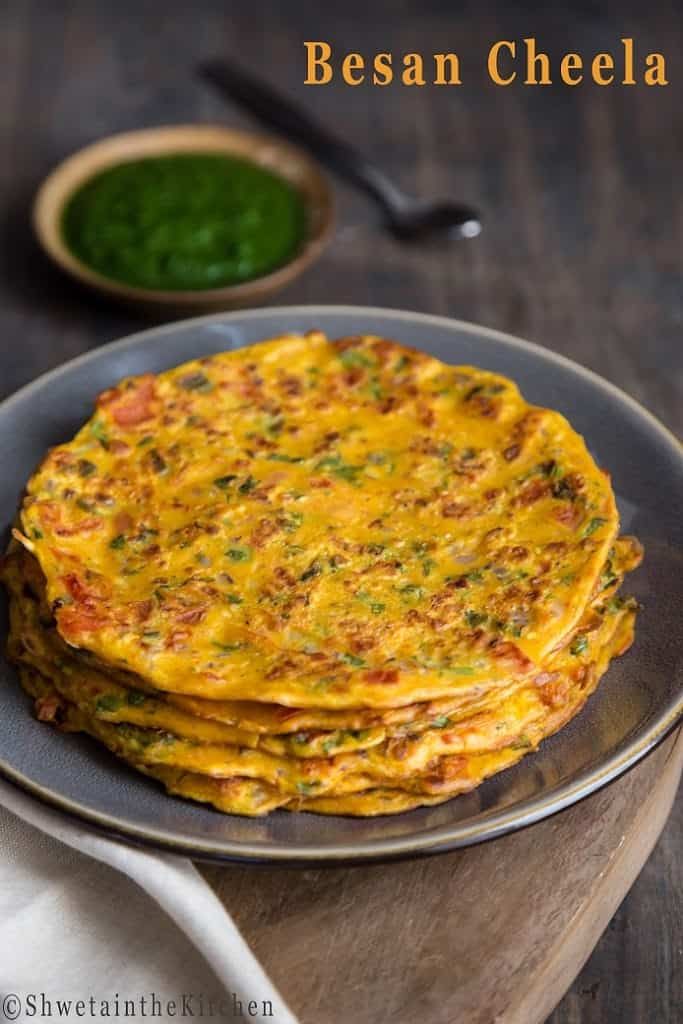 a stack of food sitting on top of a metal plate next to a bowl and spoon