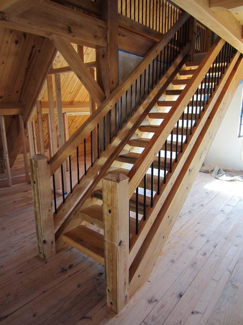 a wooden stair case in an unfinished room