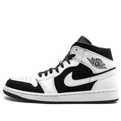 The Air Jordan 1 is a classic sneaker that needs no introduction. First released in 1985, the shoe was designed by Peter Moore and has since become one of the most popular sneakers of all time. The Air Jordan 1 Retro Mid 'Tuxedo' sneaker takes the classic design and gives it a modern twist. Released in the Fall of 2018, the 'Tuxedo' colorway features a grained leather upper withsoft nubuck overlays and signature wings logo. The heel contains an Air-Sole unit that reinforces the cushioned midsole, while the rubber outsole ensures traction to prevent slippage. (AJ1/SNKR/Panda/Men's/Mid Top/Basketball) Classic Jordan Shoes For Streetwear, Classic Mid-top Sneakers With Abzorb Midsole, Classic Sneakers With Contrast Sole For Streetwear, Classic Low-top Jordan Shoes, Classic Custom Sneakers For Streetwear With Branded Insole, Classic High-top Lace-up Sneakers For Streetwear, Classic Lace-up High-top Sneakers For Streetwear, Classic High-top Sneakers With Boost Midsole And White Sole, Classic Custom Sneakers With Rubber Sole For Streetwear