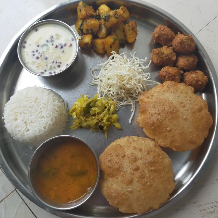 a metal plate topped with different types of food