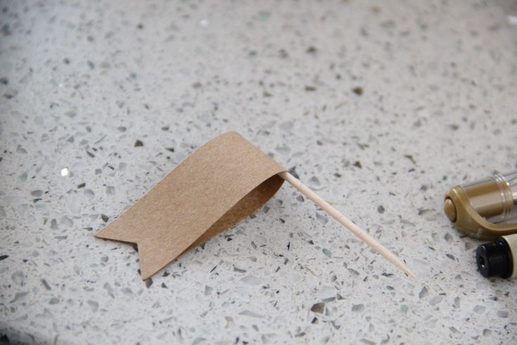 a toothbrush and some brown paper on a table