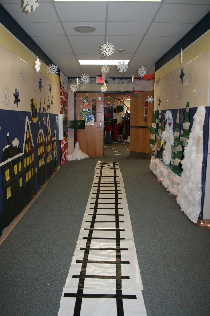 a hallway decorated for christmas with snowmen and train tracks on the floor in front of it